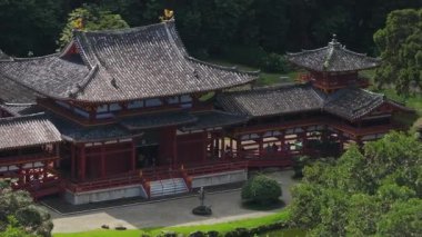 Hawaii, Oahu Adası 'ndaki Byodo Tapınağı' nın sakin havadan görünüşü, karmaşık tasarımı, kırmızı ve altın renkleri ve sakin orman çevresi sergilenmektedir..