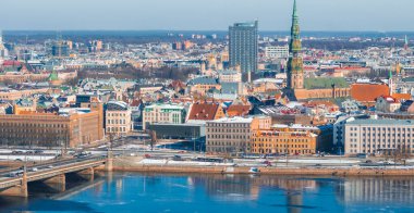 Kışın Riga, Letonya 'nın havadan görünüşü, St. Peters Kilisesi kulesi, kısmen donmuş Daugava Nehri, bir köprü ve çeşitli mimari.
