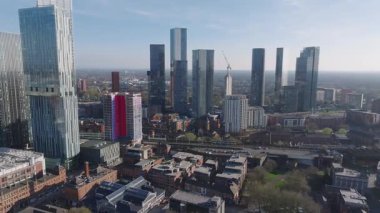 Manchester, İngiltere 'nin hava manzarası, Beetham Kulesi gibi gökdelenler, tren rayları, demiryolu köprüsü ve açık gökyüzünün altında renkli bir bina..