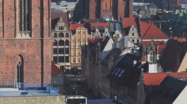 Wroclaw, Polonya 'nın havadan görünüşü, St. Mary Magdalene Kilisesi, tarihi çatılar, modern binalar, ve açık gökyüzünün altında bir inşaat vinci.
