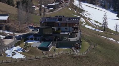 Hava hareketi, camdan pencereleri, ahşap aksanları, sonsuz havuzu ve İtalya 'nın güney Tyrol kentindeki Dolomitlerin manzarası olan modern bir oteli yakalar..