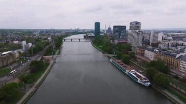 Frankfurt, Almanya 'nın havadan görünüşü, Ana Nehir, Holbeinsteg Köprüsü, Westhafen Kulesi, rıhtım teknesi, hafif trafik ve yemyeşil alanları gösteriyor..