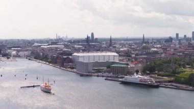 Kopenhag, Danimarka 'nın havadan görünüşü, liman, Opera Binası, Copenhill Elektrik Santrali, savaş gemileri, yatlar, ve uzak Öresund Köprüsü.