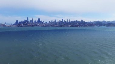 San Francisco 'nun gökyüzü manzarası. Satış Gücü Kulesi ve Transamerica Piramidi. Yumuşak dalgalar açık mavi gökyüzünün altında hareket eder..