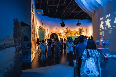 Ziyaretçiler fütüristik tasarımlar, palmiye ağaçları, manzara gibi çöl ve Osaka 'daki 2025 Dünya Fuarı' nda dijital zaman çizelgesi bulunan canlı bir sergi keşfediyorlar..