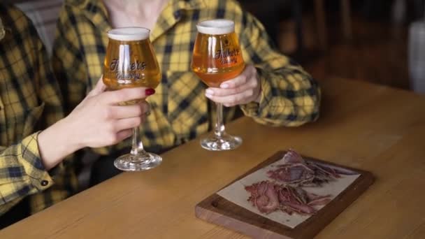 バーでビールを飲みながら会議を楽しんでいる彼女たち 若い人たちは冷たい生ビールを飲み パブで楽しい時間を過ごす — ストック動画