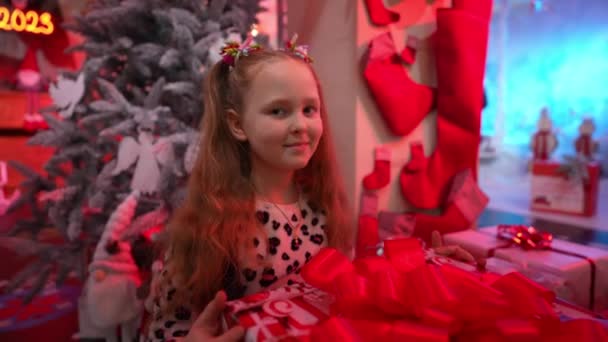 Childrens Christmas Girl Looks Gift Box Red Bow Twists Her — Stock Video