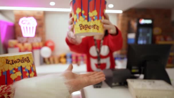 Christmas Girl Gives Santa Bucket Popcorn Watch Movies — Stockvideo