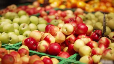 Delicious ripe big round red apples on the store counter.