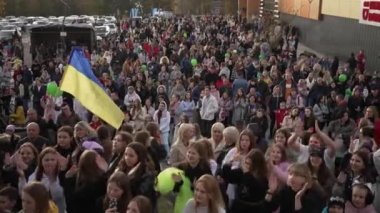 Satisfied people dance and applaud their favorite performer