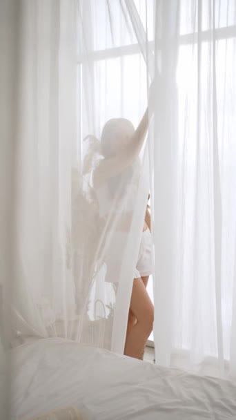 Seductive Young Girl Stands Window Smiles Happily — Stock Video