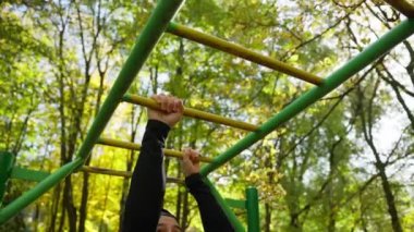 Athletic man with muscular body is exercising outdoors. Strength and motivation