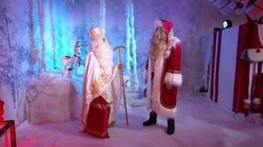 Saint Nicholas and Santa Claus are preparing to distribute holiday gifts to children