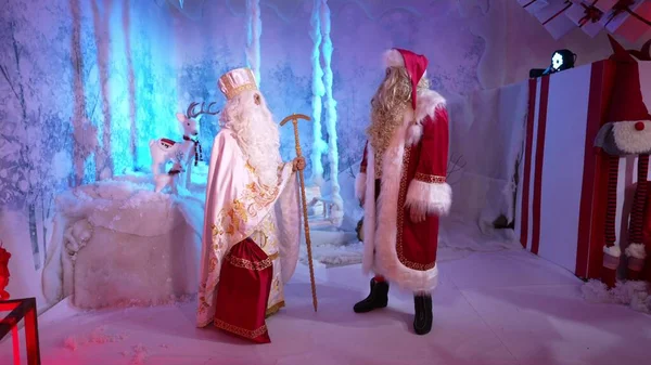 Saint Nicholas and Santa Claus are preparing to distribute holiday gifts to children