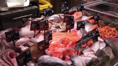 Red trout fish are sold in the shop window. Tasty and healthy seafood, frozen. Fish shop - bazaar. Sale of fish on counters ready for sale.