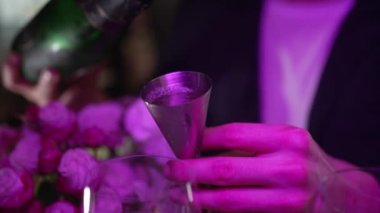 Bartender mixing cocktail with drinking glass at bar, close up Barman hand pouring a alcohol drinks into glass