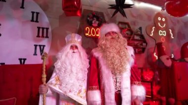 Santa Claus and Saint Nicholas on a festive background 4K