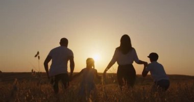 dad and mom are having fun playing with children in nature