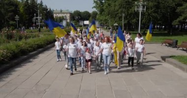 Children, together with adults, pass through the city center in support of Ukrainian soldiers