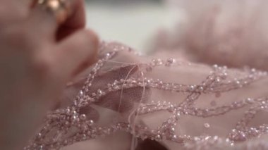 Decorate the dress with beads and sequins