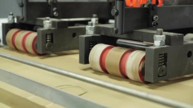 A production machine used for the production of packages. Automated production makes handles for eco bags. A modern machine for the production of packages at the factory.