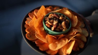 Bira için atıştırmalıklar kasede, yakın plan. Fıstık, cips ve kızarmış ekmek kasesinde.