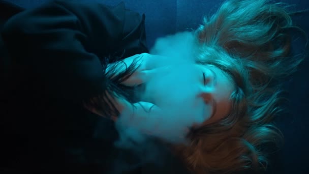 Close Seductive Girl Lying Couch Exhaling Smoke Illuminated Blue Neon — Stock Video