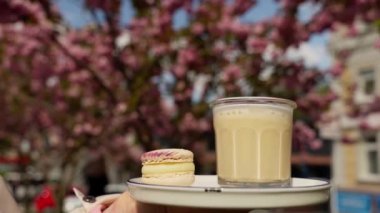Kahve, servis. Müşteri hizmetleri için tepsi ve kahve ve tatlı sipariş eden bir kadın eli. Küçük bir işletme, latte, kafein ve espresso servis eden bir kafe.