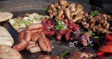 Şef yaz barbekü partisinde ızgarada et ve sebze pişiriyor.