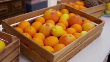 Taze sarı limonlar, ahşap bir kutuda portakallar.