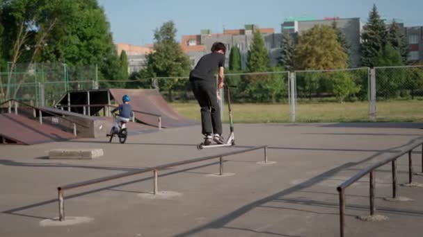 Кавказский Подросток Делает Трюки Друзьями Скейт Парке — стоковое видео
