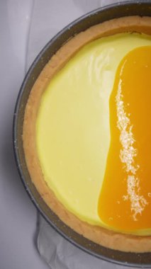 Profesyonel bir mutfakta sıcak çikolatayla kaplı, beyaz kremalı lezzetli bir pasta. Erimiş karamel kaplı panna cotta ağır çekimde.