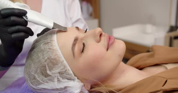 美容師は顔のしわを減らし 皮膚を若返らせ 顔を持ち上げるための手順を実行する — ストック動画
