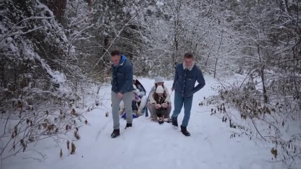 家族と一緒に雪に覆われたトレイルを通って楽しいスリーライド — ストック動画