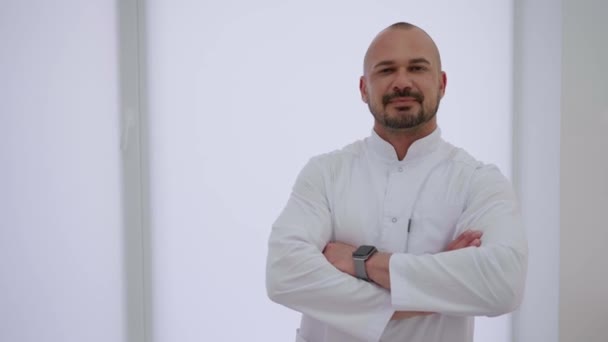 Young Man White Shirt Stands His Arms Crossed White Room — Stock Video