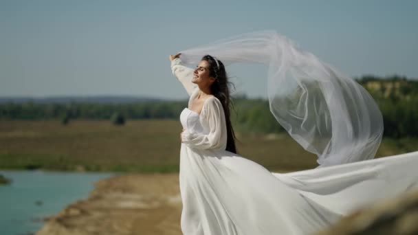 Bride White Dress Holds Veil Blown Wind Rock Sea — Stock Video
