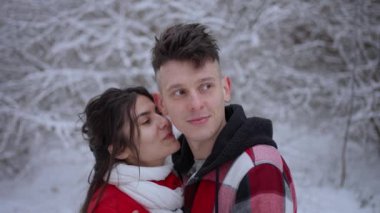 Karlı kış ormanlarında bir çift hassas bir anı paylaşıyor..