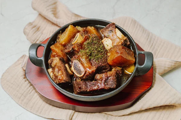 Beef short ribs, trimmed of fat, seasoned in sweet soy sauce, and braised until tender with carrots, chestnuts, ginko nuts, and other vegetables.