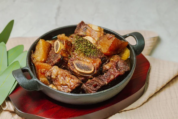 Beef short ribs, trimmed of fat, seasoned in sweet soy sauce, and braised until tender with carrots, chestnuts, ginko nuts, and other vegetables.