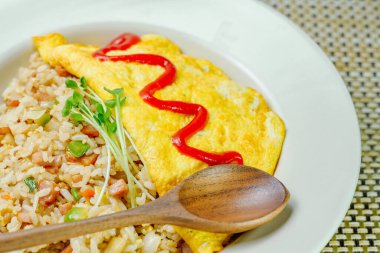 Beyaz tabakta servis edilen omlet pilavı.