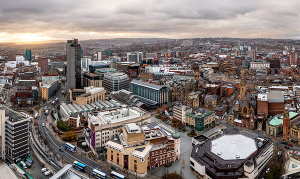 SHEFFIELD, UK - DECEMBER 6, 2022.  An aerial panorama of Sheffield city centre cityscape skyline at sunset with The Arts Tower, Winter Gardens and Crucible Theatre in the retail district