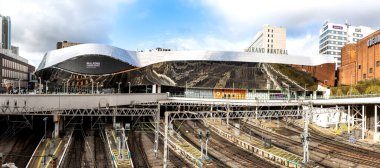 BIRMINGHAM, UK - FEBRUARY 22, 2023.  A panoramic view of the South entrance to Birmingham New Street railway station with rail tracks and platforms under the Bullring and Grand Central retail centre