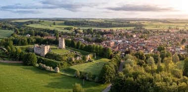 Aerial panorama of Helmsley Castle and town with surrounding North Yorkshire Moors countryside at surise clipart