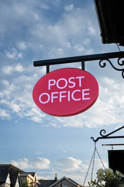 An old fashioned Post Office sign hanging outside a main street Post Office or traditional sub post office with copy space