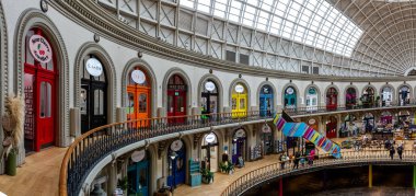 Corn Exchange, Leeds, İngiltere - 14 Ağustos 2023. Tarihi Leeds Mısır Borsası 'nın renkli bir mimarisi. Üst balkondaki küçük bağımsız perakende şirketlerinin sıraları.