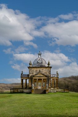 CASTLE HOWARD, YORK, UK - MARCH 23, 2024.  A vertical panoramic landscape of The Temple Of The Four Winds in the gardens of the British Stately Home of Castle Howard on a bright sunny day with copy space clipart
