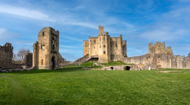 WARKWORTH CASTLE, NORTHUMBERLAND, UK - MARCH 16, 2024. Panoramic landscape of the interior of Warkworth Castle with the cross shaped Keep and ruins with copy space clipart