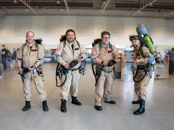 stock image HARROGATE, UK - JUNE 22, 2024. A group of male middle aged cosplayers dressed as Ghostbusters at a comic con event