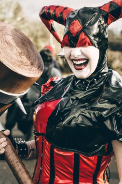 BIRMINGHAM, UK - NOVEMBER 30, 2024. A close up of a pretty girl cosplayer dressed as Harley Quinn from the Batman franchise laughing and having fun at a comic con event clipart