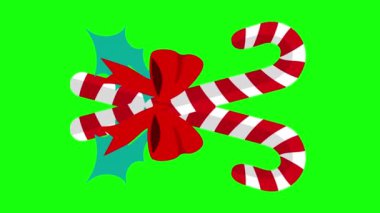 Kırmızı kurdele ve şeker kamışları yeşil arka planda hareket ediyor